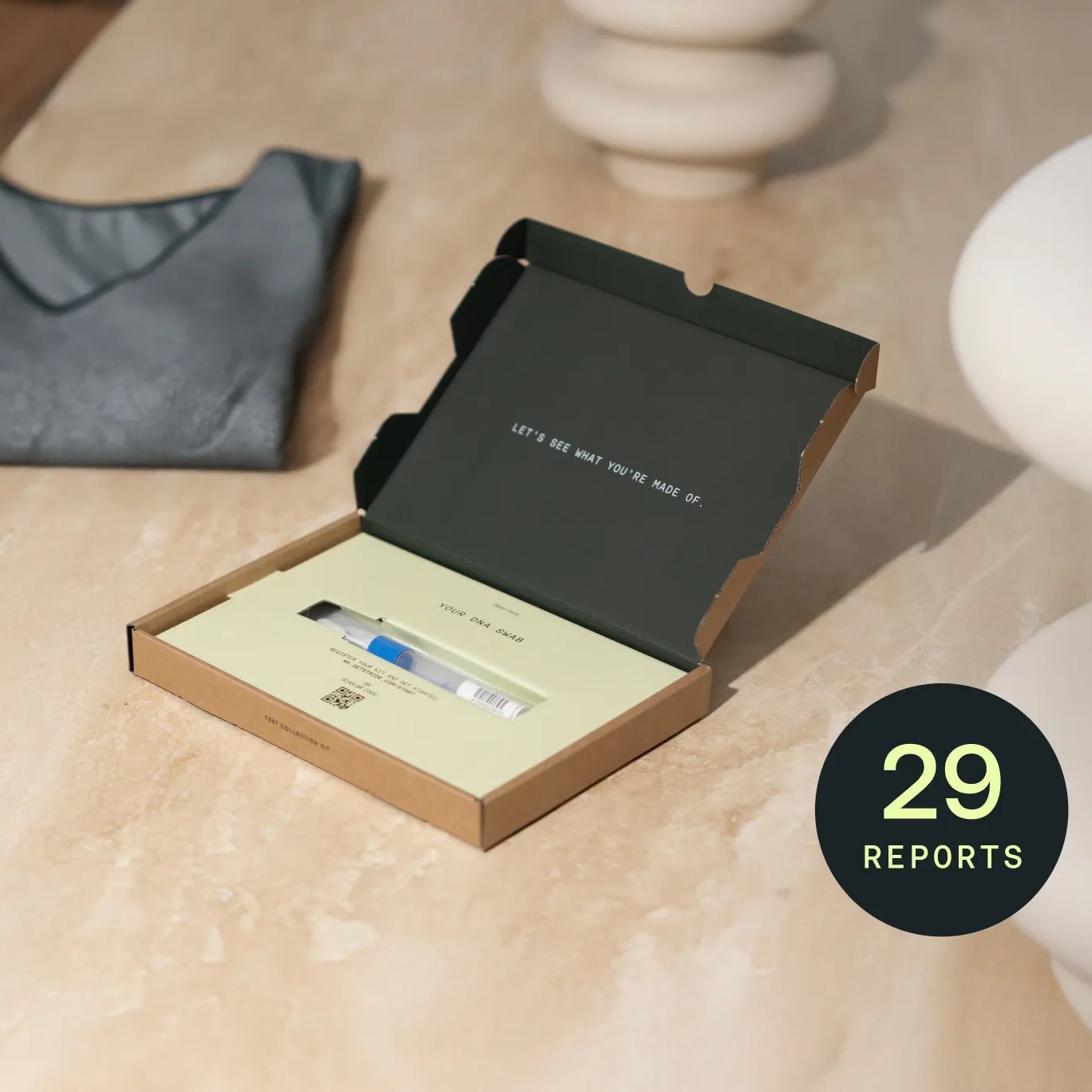 DNA kit in a box on a marble surface with '29 Reports' text.